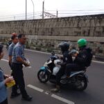Petugas Lapas Kelas I Cipinang, Jatinegara, Jakarta Timur, saat membagikan paket takjil kepada warga di Jalan Bekasi Timur Raya pada Senin (1/4) sore. Foto: Joesvicar Iqbal/ipol.id